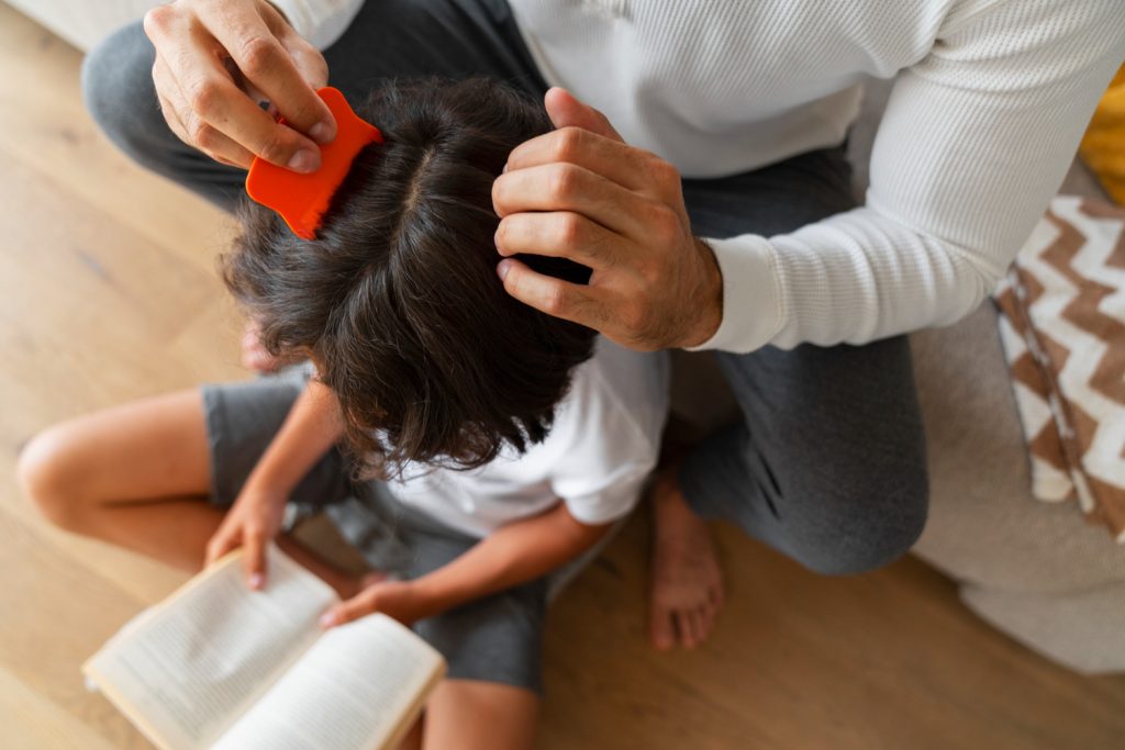 Father Using Nit Comb